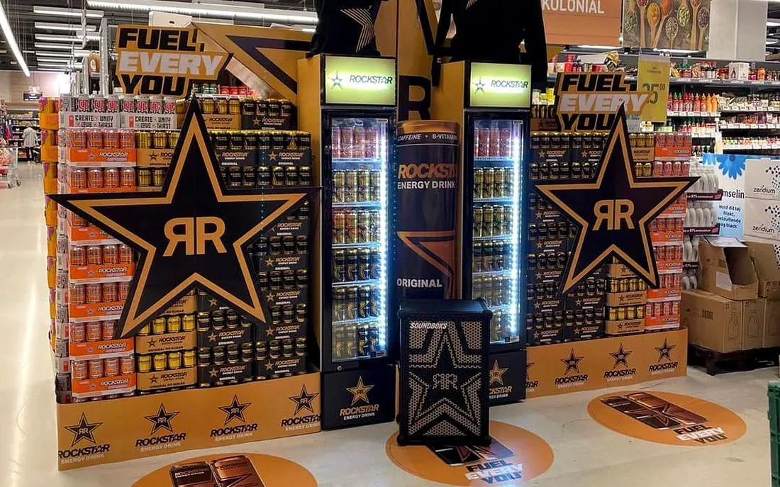 Rockstar Energy Fuel Every You in-store display: a large star-shaped stand with fridges, stacked cans, merchandise and Fuel Every You floor stickers