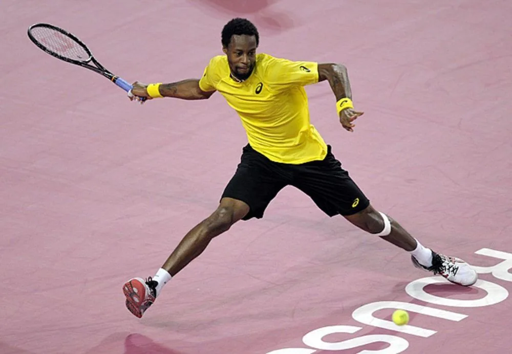 Tennis player in ASICS apparel and shoes