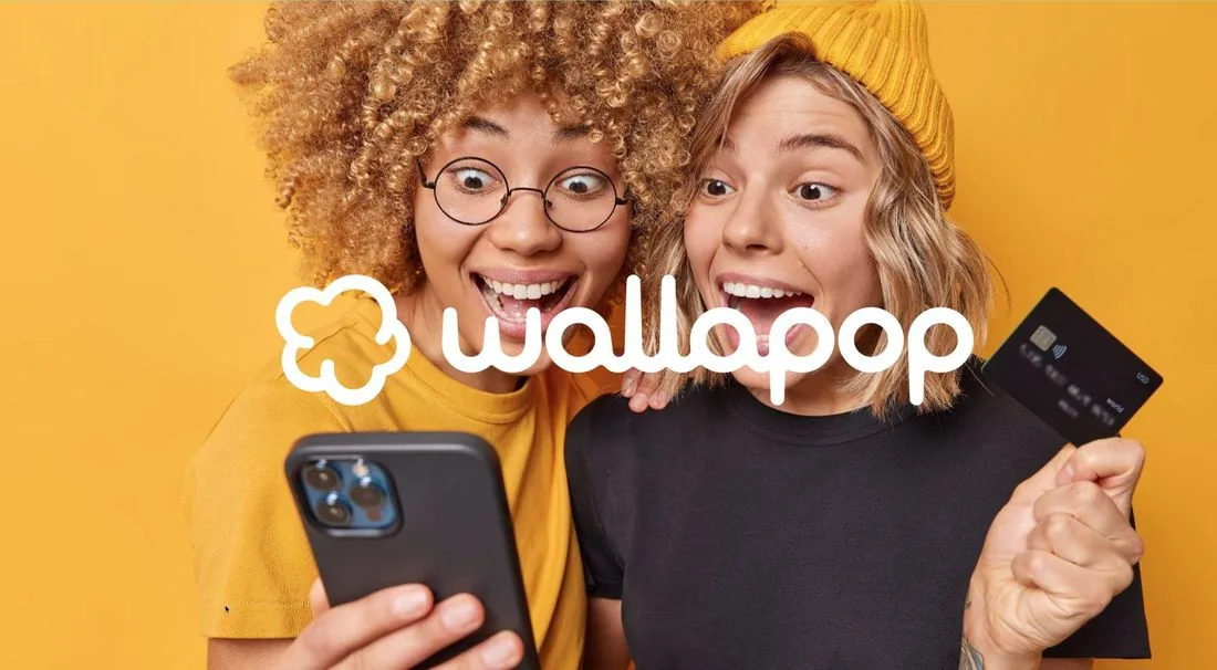 Wallapop brand image: two excited young women looking at a phone, one holding a bank card, with the Wallapop logo